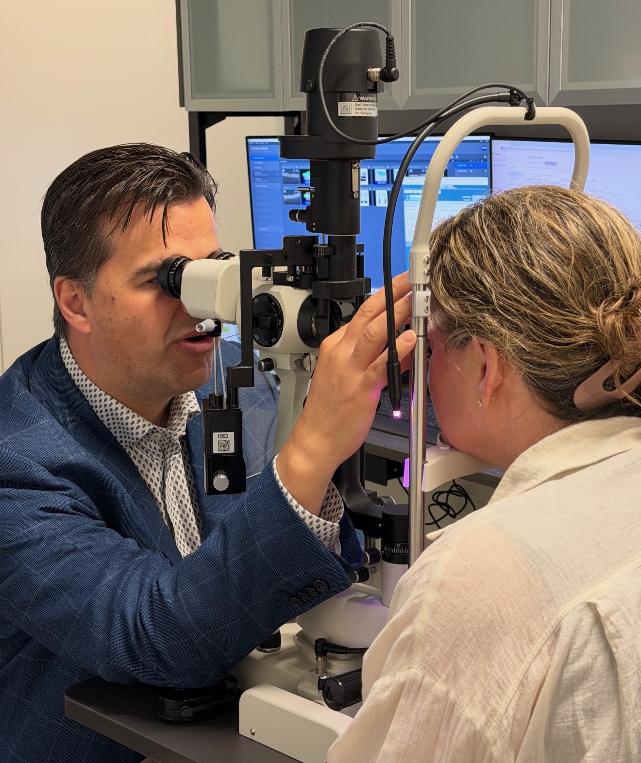 Dr. Marius Scheepers examining a patient at the slit lamp in clinic